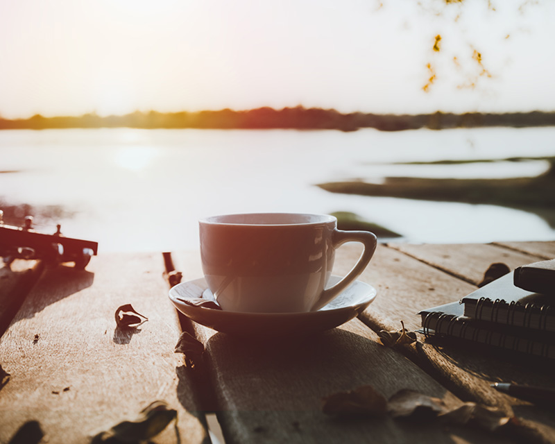 Coffee cup by a lake